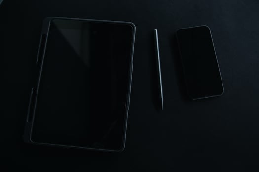 Open laptop with digital tablet and white smartphone. All with isolated screen on old wooden desk. photo