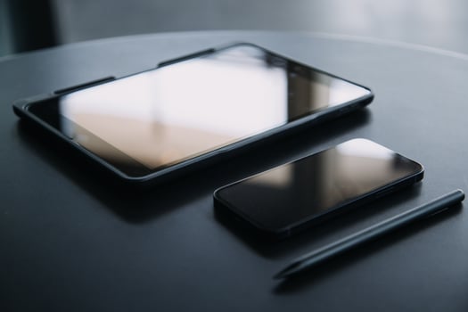 Open laptop with digital tablet and white smartphone. All with isolated screen on old wooden desk. photo
