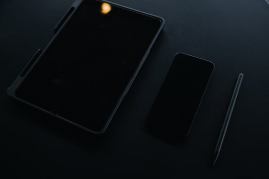Open laptop with digital tablet and white smartphone. All with isolated screen on old wooden desk. photo