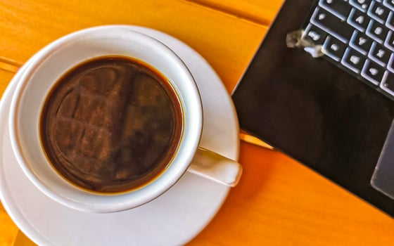 Laptop work at table with coffee cup in Mexico. photo