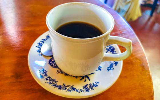 Blue white cup pot with black coffee wooden table Mexico. photo