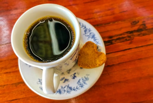Blue white cup pot with black coffee wooden table Mexico. photo