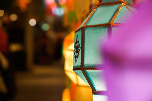 Closeup Colorful Thai Lanna style lanterns to hanging and turn on light at night. photo