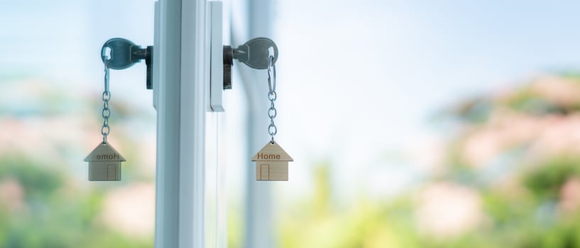 Landlord key for unlocking house is plugged into the door. Second hand house for rent and sale. Owner use hand unlock door mortgage for new home, buy, sell, renovate, investment, owner, estate photo