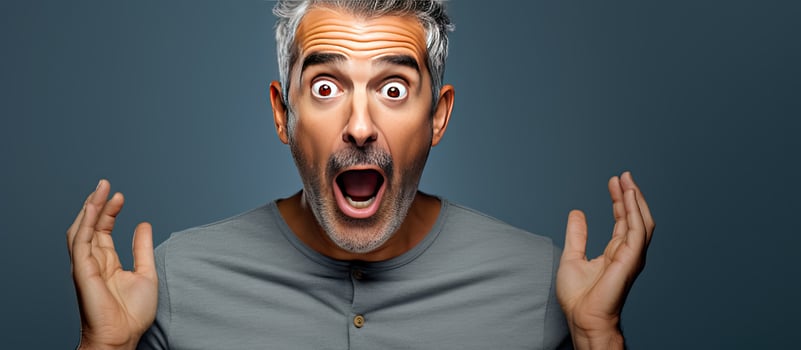 Middle aged man in awe pointing upwards with both hands towards empty area photo