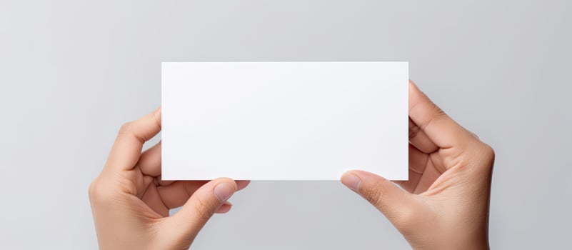 Caucasian woman s hand holds white card for business purposes photo