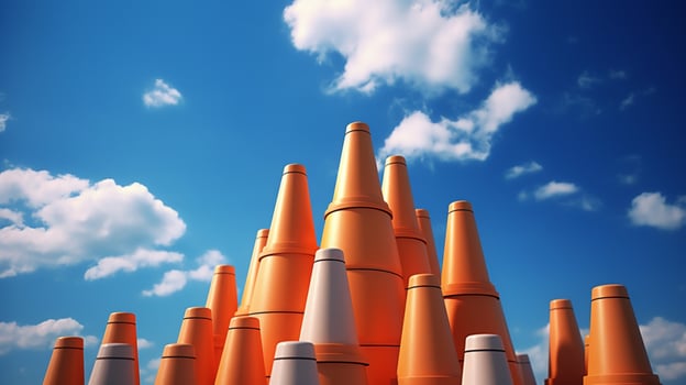 traffic cones in a stack with blue sky and clouds photo