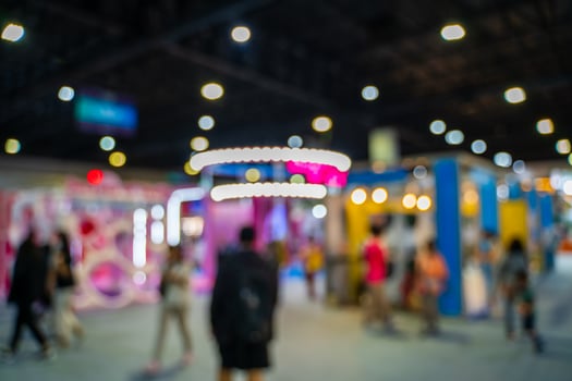 Blurred images of trade fairs in the big hall. image of people walking on a trade fair exhibition or expo where business people show innovation activity and present products in a big hall. photo
