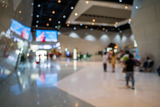 Blurred images of trade fairs in the big hall. image of people walking on a trade fair exhibition or expo where business people show innovation activity and present products in a big hall. photo