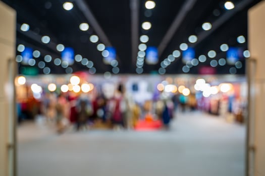 Blurred images of trade fairs in the big hall. image of people walking on a trade fair exhibition or expo where business people show innovation activity and present products in a big hall. photo