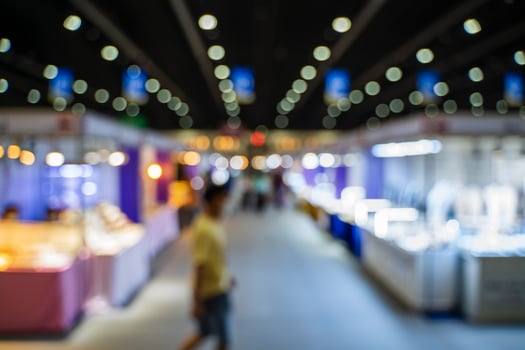 Blurred images of trade fairs in the big hall. image of people walking on a trade fair exhibition or expo where business people show innovation activity and present products in a big hall. photo