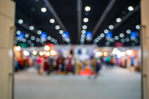 Blurred images of trade fairs in the big hall. image of people walking on a trade fair exhibition or expo where business people show innovation activity and present products in a big hall. photo