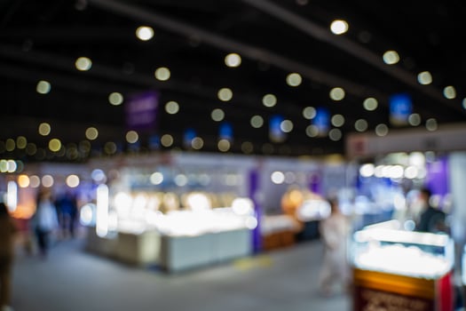 Blurred images of trade fairs in the big hall. image of people walking on a trade fair exhibition or expo where business people show innovation activity and present products in a big hall. photo