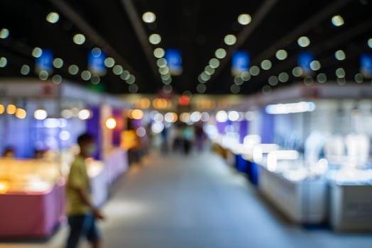 Blurred images of trade fairs in the big hall. image of people walking on a trade fair exhibition or expo where business people show innovation activity and present products in a big hall. photo