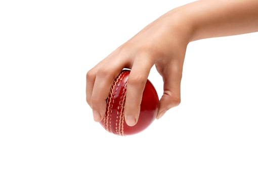 A Female Hand Holding A Red Test Match Leather Stitch Cricket Ball Closeup Photo White Background