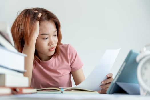 Asian student woman have anxiety because of exams, female prepare for test and learning lessons in the library. stress, despair, haste, misunderstanding reading, discouraged, expectation, knowledge photo