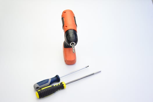 Electric screwdriver and hand screwdriver set on white background photo