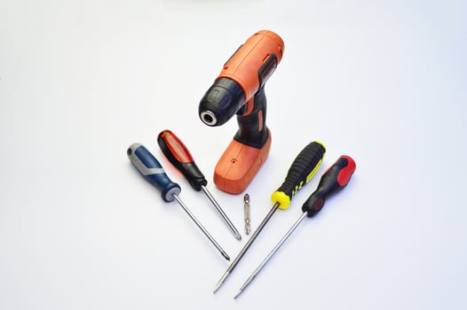 Electric screwdriver and hand screwdriver set on white background photo