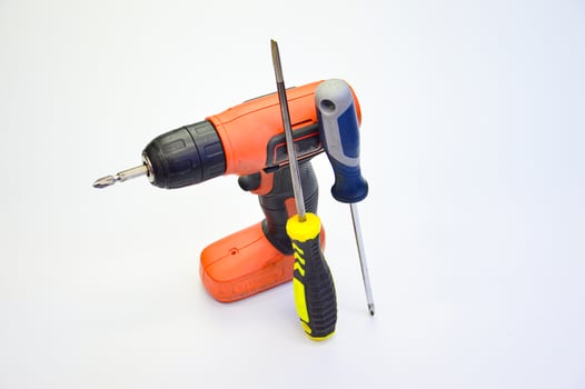 Electric screwdriver and hand screwdriver set on white background photo
