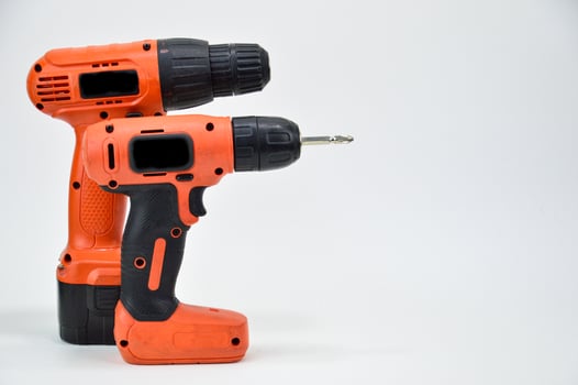 Electric screwdriver on white background, orange screwdriver photo