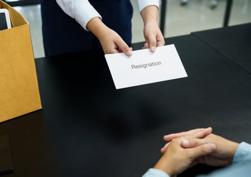 Business woman sending resignation letter to boss and Holding Stuff Resign Depress or carrying cardboard box by desk in office photo