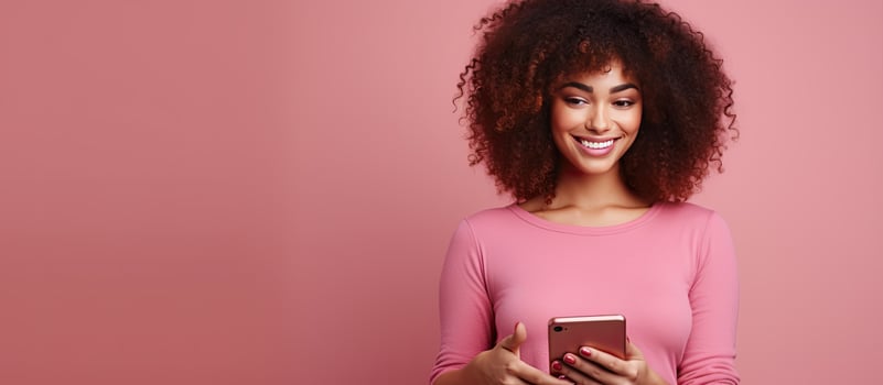 Female blogger with curly hair and pink outfit holding phone for video call on a pink background with technology and social media elements online presence photo