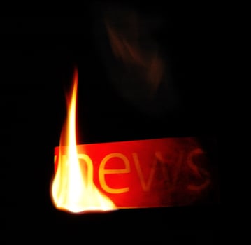 Hot news. Newspaper fire text. photo
