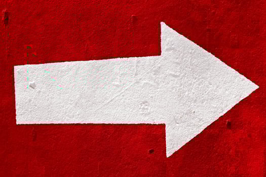 White arrow on the red concrete. photo