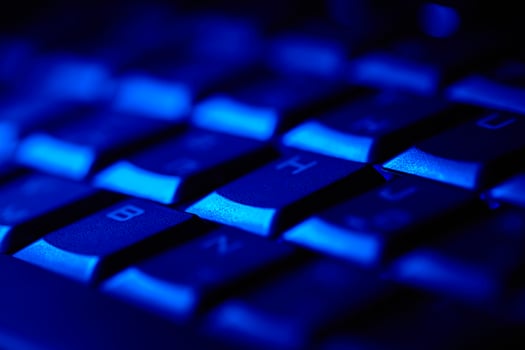 Computer keyboard in blue light. photo