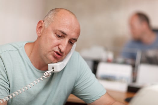 Businessman talking on phone in office photo