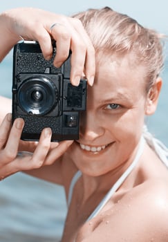 Woman laughing as she views a photo