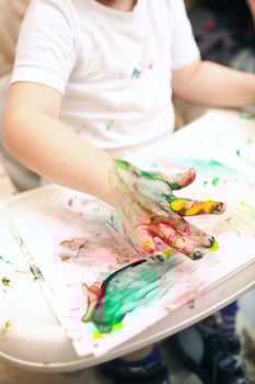 Boy painting with finger-paints photo