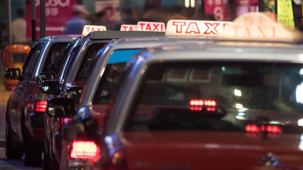 Taxi cars parked in row at night photo