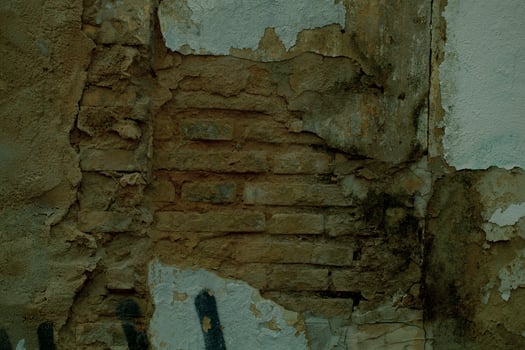 Exposed brickwork on an old damaged wall photo