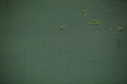 Green wall background texture with flaky paint photo