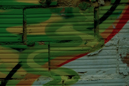 Striated pattern bricks with colorful graffiti photo
