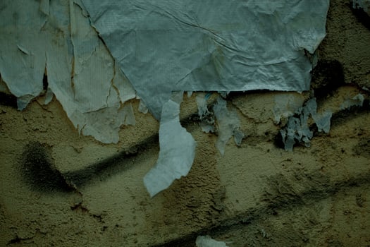 Peeling paper and plaster on a grunge damp wall photo