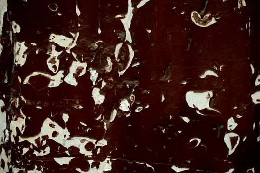 Old wooden panel with grungy peeling dark paint photo