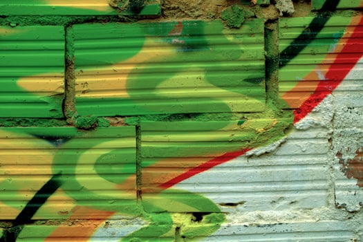 Striated pattern bricks with colorful graffiti photo