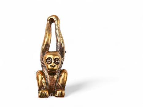 Golden monkey statue on white background photo