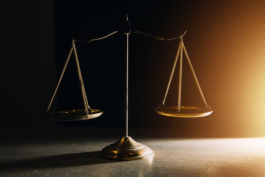 Business and lawyers discussing contract papers with brass scale on desk in office. Law, legal services, advice, justice and law concept picture with film grain effect photo