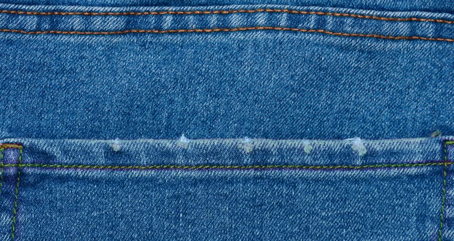Fragment of the back pocket of blue jeans photo