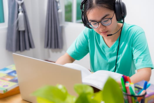 Asian woman serious reading a book learning online photo