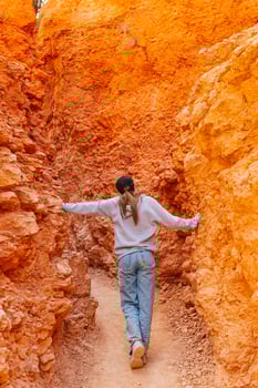 Hiker girl in Bryce Canyon hiking relaxing looking at amazing view during hike on summer travel in Bryce Canyon National Park, Utah, United States. photo