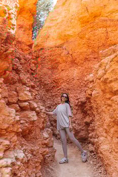 Hiker woman in Bryce Canyon enjoying hike in beautiful landscape with hoodoos, pinnacles and spires rock formations in Utah, United States. photo