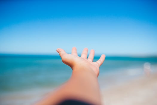 Closeup hand on background of the sea and sky photo