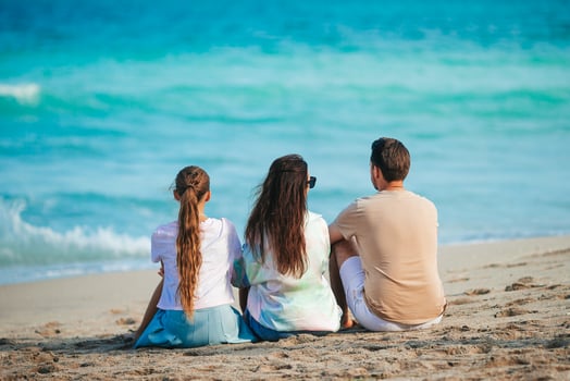 Happy family on the beach during summer vacation photo