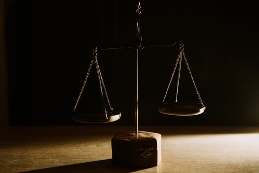 Business and lawyers discussing contract papers with brass scale on desk in office. Law, legal services, advice, justice and law concept picture with film grain effect photo
