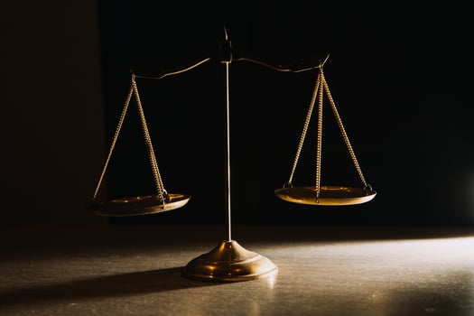 Business and lawyers discussing contract papers with brass scale on desk in office. Law, legal services, advice, justice and law concept picture with film grain effect photo