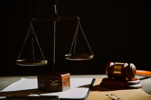 law legal technology concept. judge gavel on computer with scales of justice on desk of lawyer. photo